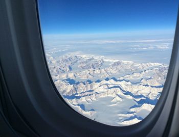 Aerial view of landscape seen through airplane window