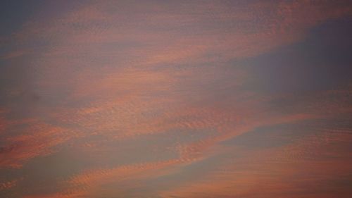 Low angle view of cloudy sky at sunset