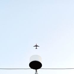 Low angle view of airplane against clear sky