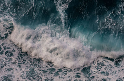 High angle view of waves breaking on sea shore