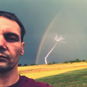 Portrait of man against illuminated light painting