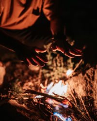 Close-up of hand with fire crackers at night