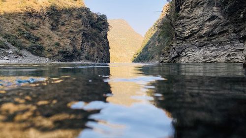 Surface level of water on rock against sky