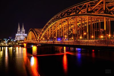 Illuminated hohenzollern bridge over rhine river at night