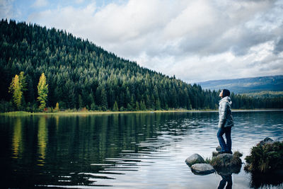 Rear view of man on lake against sky