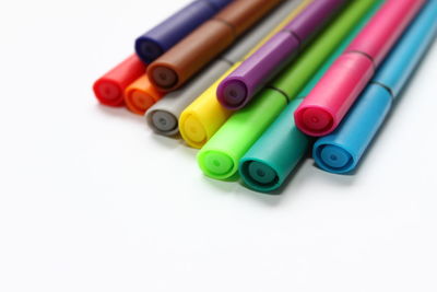 High angle view of colored pencils on white background