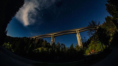 Low angle view of bridge against sky at night