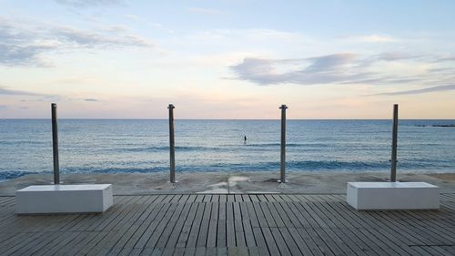 Scenic view of calm sea against cloudy sky