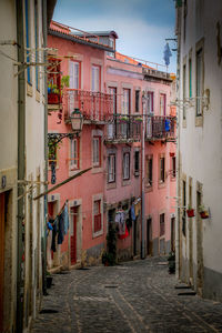 Narrow street amidst buildings in city