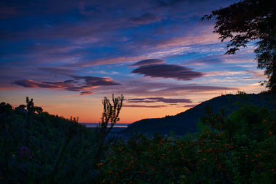 Scenic view of silhouette mountains against sky during sunset