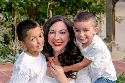 Happy mom and her two boys in a family portrait