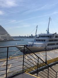 Ship moored at harbor against sky