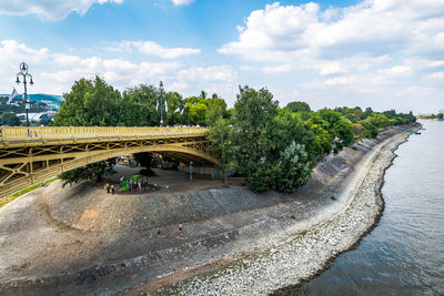 Arch bridge over river against sky