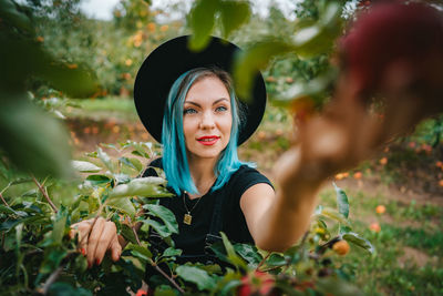 Portrait of smiling young woman with leaves