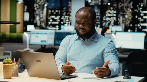 Portrait of young woman using mobile phone at cafe