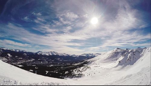 Scenic view of mountains against cloudy sky