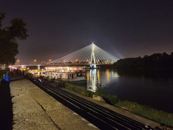 Illuminated bridge over river against sky at night. swietokrzyski bridge in warsaw. 