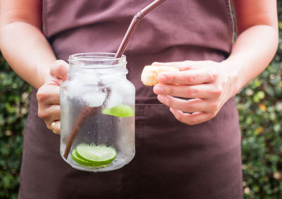 Midsection of man holding drink