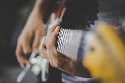 Close-up of man playing guitar