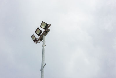 Low angle view of security camera against sky