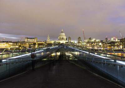 Illuminated cityscape against sky at night