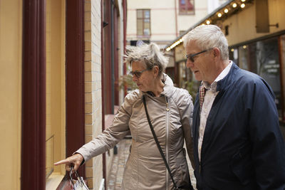 Mature couple looking at shop window