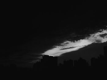 Buildings in city against cloudy sky