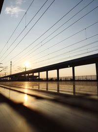 Bridge over river against sky during sunset