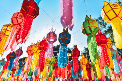 Low angle view of lanterns hanging against sky