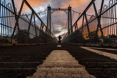 Silhouette bridge against sky during sunset