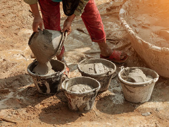 Low section of man working in mud