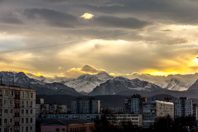 Panoramic shot of cityscape against sky during sunset