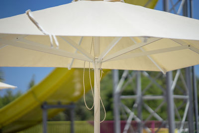 Close-up of yellow umbrella against sky