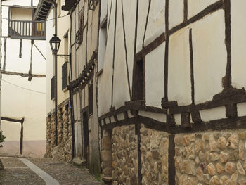Empty alley amidst buildings in city