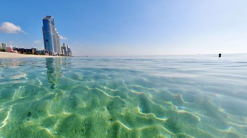 View of a calm sea and city skyline