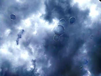 Low angle view of bubbles against moon