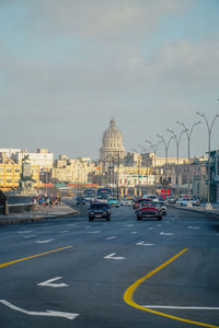 Cars on road against sky