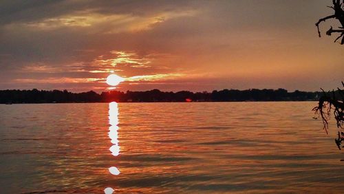 Scenic view of lake at sunset