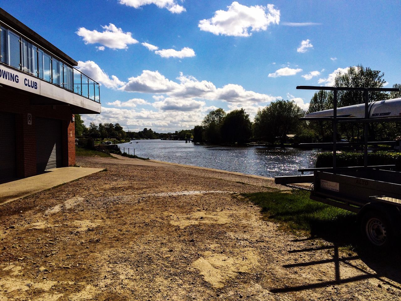 sky, tree, water, cloud - sky, cloud, built structure, tranquility, tranquil scene, building exterior, sunlight, architecture, blue, nature, day, shadow, outdoors, river, no people, lake, the way forward