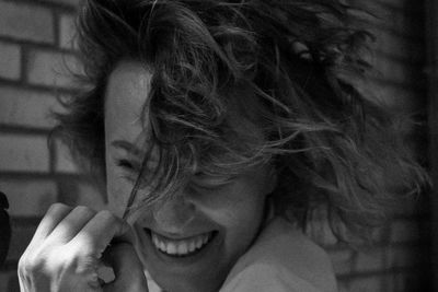 Close-up of smiling woman with tousled hair