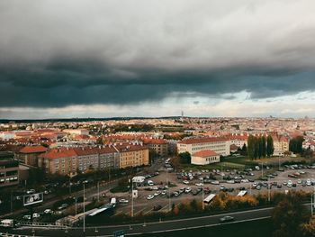 Aerial view of cityscape against cloudy sky