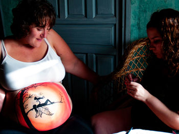 Young couple sitting in front of woman