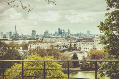 View of cityscape against cloudy sky