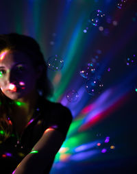 Portrait of woman in illuminated nightclub