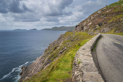 Road by sea against sky