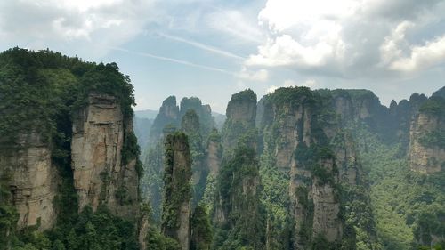 Scenic view of mountain against cloudy sky