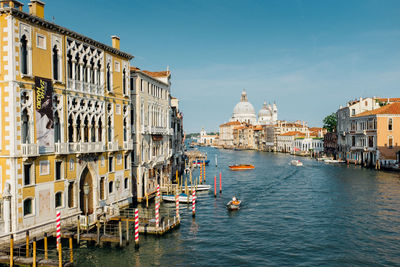Boats in river with buildings in background