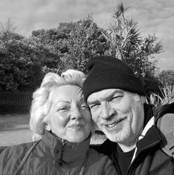 Close-up portrait of couple standing against trees