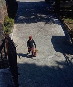 High angle view of man walking on footpath