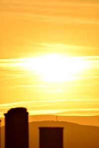 Silhouette buildings against sky during sunset